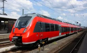 An image of a red train waiting to leave a station