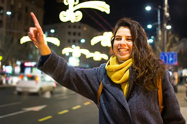 An image of a woman hailing a cab